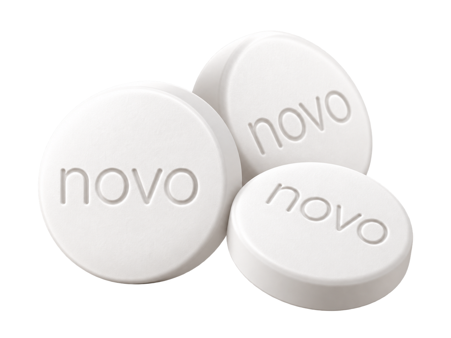 Three Wegovy semaglutide tablets, each embossed with the Novo Nordisk mark